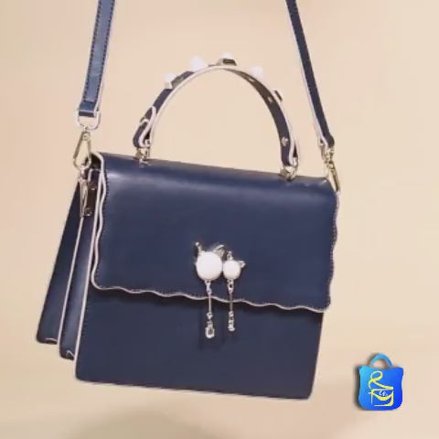 video of a blue studded handle crossbody bag