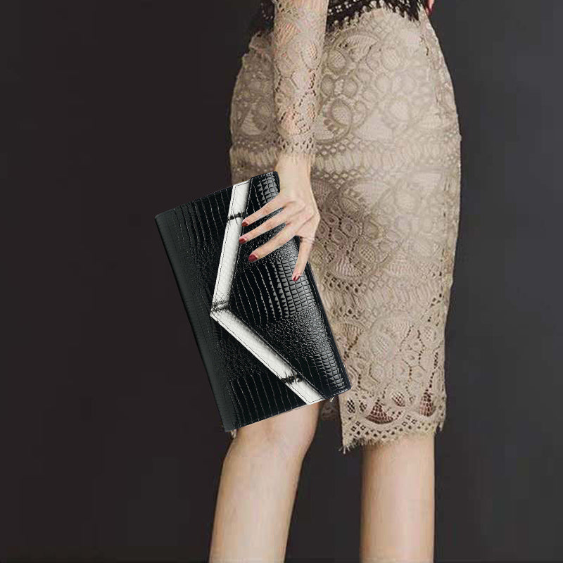 model holding a black and white double flap clutch bag